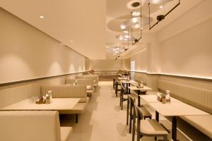 a restaurant dining room with tables and chairs at Regenta Place CG Road in Ahmedabad