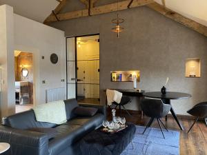 a living room with a couch and a table at The Loft at Design Bank in Milltown Malbay