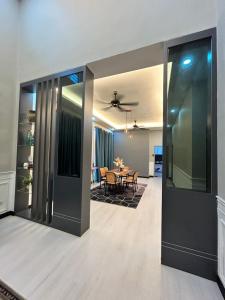 a living room with a table and a dining room at NovaStay Melaka in Kampong Kerubong