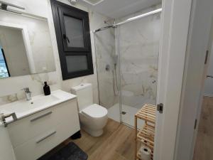 a bathroom with a shower and a toilet and a sink at Private Garden Apartment - Villamartin, Orihuela Costa in Villamartin +13 photos