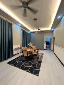 a dining room with a table and chairs and a ceiling at NovaStay Melaka in Kampong Kerubong