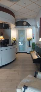 a lobby of a store with a large door with flowers at Residence H5 in Piacenza