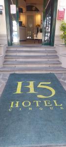 a sign on the ground in front of a building at Residence H5 in Piacenza +10 photos