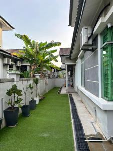 a courtyard of a house with green grass at NovaStay Melaka in Kampong Kerubong