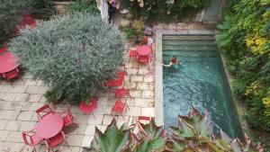 an overhead view of a woman in a swimming pool at Hotel Les Templiers in Aigues-Mortes