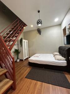 a bedroom with a bed and a staircase at NovaStay Melaka in Kampong Kerubong
