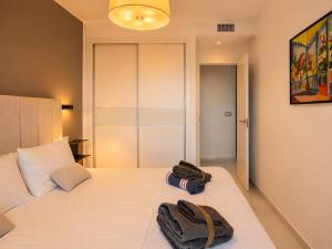 a bedroom with a bed with two bags on it at Infinity View Penthouses by NRAS in Arenales del Sol +31 photos
