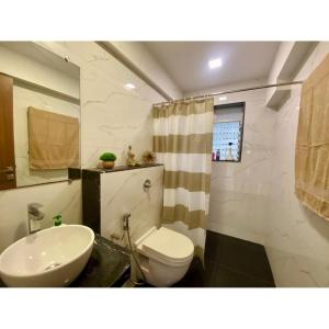 a bathroom with a white toilet and a sink at Modern 2bed Bandra AreaParkingUnit 2 in Mumbai +34 photos