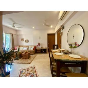 a living room with a table and a couch at Modern 2bed Bandra AreaParkingUnit 2 in Mumbai