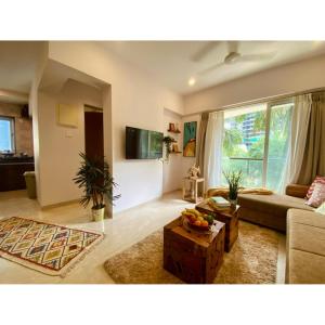 a living room with a couch and a table at Modern 2bed Bandra AreaParkingUnit 2 in Mumbai