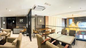 a living room with a glass table and chairs at Imperial Heritage Hotel Melaka I City Centre I Free Wifi I Free Parking l Free Club Lounge Access in Malacca