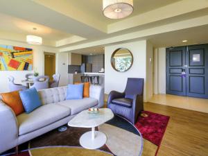 a living room with a couch and a table at Mercure Penang Beach in George Town