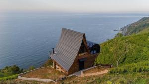 a small chapel on a hill next to the ocean at Himora Suit Bungalov in Ardeşen
