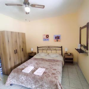 a bedroom with a bed with two towels on it at Niki's house 2 in Agia Triada