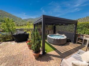 a black gazebo with a hot tub at Il Posto delle Rose 1 in San Polo dei Cavalieri