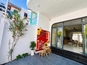 a building with a large window and plants on it at Punica Homestay in Tuy Hoa
