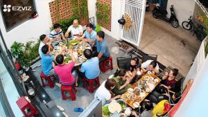 a group of people sitting at a table eating food at Punica Homestay in Tuy Hoa
