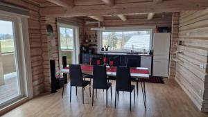 a kitchen with a table and chairs in a cabin at Taga-Kalda in Nüpli