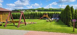 a park with a playground with a swing at Ojcowski Las in Biały Kościół
