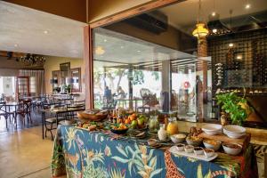 a table with food on it in a restaurant at Buhala Lodge in Malelane