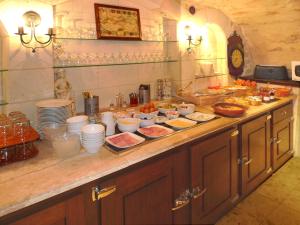 a kitchen counter with many dishes of food on it at Hôtel Du Manoir in Tours