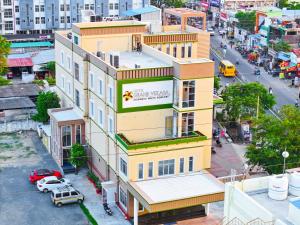 an overhead view of a yellow building with a sign on it at Hotel Grand Vekasa in Salem