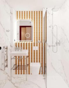 a bathroom with a sink and a toilet and a mirror at Grand Hôtel De Turin in Paris