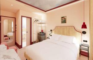a bedroom with a large white bed in a room at Grand Hôtel De Turin in Paris