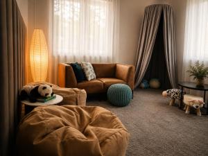 a living room with a chair and a stuffed bear on a table at Vila Zornička in Ždiar