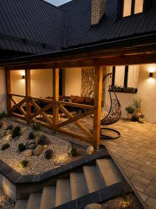 a patio with a wooden fence in front of a house at Vila Zornička in Ždiar