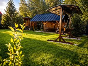 a gazebo and a bench in a yard at Vila Zornička in Ždiar +33 photos