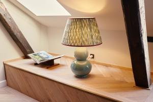 a lamp on a table with a book at Ascot Hotel in Copenhagen