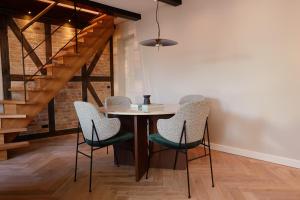 a dining room with a table and four chairs at Ascot Hotel in Copenhagen