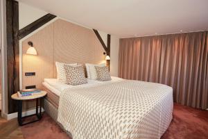 a bedroom with a large bed and a table at Ascot Hotel in Copenhagen +75 photos