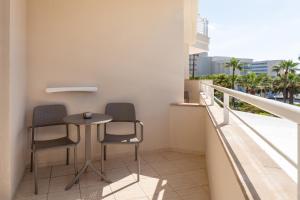 a balcony with two chairs and a table at Cala Millor Garden Hotel - Adults Only in Cala Millor +67 photos