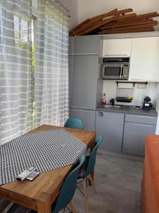 a kitchen and dining room with a table and chairs at ILK Residence 3 in Balatonalmádi