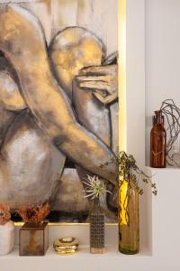 a painting on a wall with vases on a shelf at Solemare in Bonifacio