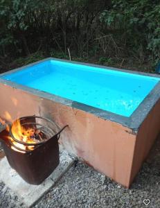 a pool of water with a pot and a fire at Hartbeest Bush Stay #6 in Hartbeespoort
