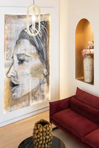 a living room with a painting of a woman at Solemare in Bonifacio