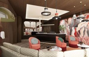 a lobby with a couch and chairs and a counter at Grand Hôtel De Turin in Paris +3 photos