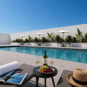 a table with wine glasses and a bowl of fruit next to a pool at Borgo Dragani in Ortona