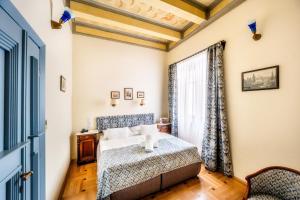 a bedroom with a bed and a window at Hotel Elite Prague in Prague