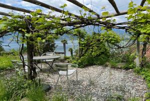 a table and chairs sitting under a pergola at Serenita in Gambarogno