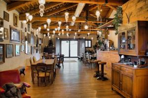 a restaurant with wooden floors and tables and chairs at Villa Stecchini in Bassano del Grappa
