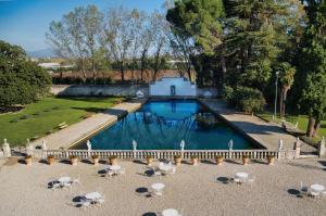 a swimming pool in a yard with chairs and a building at Villa Stecchini in Bassano del Grappa