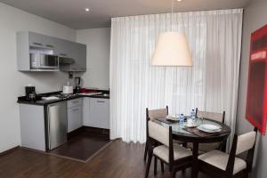 a kitchen and dining room with a table and chairs at Suites Ganges in Mexico City