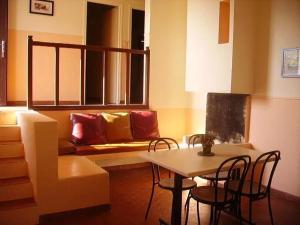 a living room with a couch and a table and chairs at Camping 3 étoiles - Piscine - ccbgbeh in Puy-lʼÉvêque