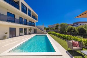 a swimming pool in the backyard of a house at Luxury apartment LaRiv II with pool in Krk