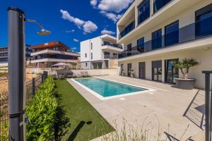 a swimming pool in the backyard of a house at Luxury apartment LaRiv II with pool in Krk