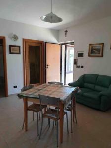 a living room with a table and chairs and a couch at JV Country in Polignano a Mare